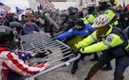 Supporters of then-President Donald Trump tried to break through a police barrier on Jan. 6, 2021, outside the U.S. Capitol, where a vote affirming th