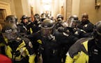 Riot police clear the hallway inside the Capitol on Jan. 6, 2021, in Washington, D.C.