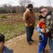 Caroline Clarin, right, hugs Haiwad Massoodi, 9, on a visit by his father, Sami, rear left, and Sami Massoodi’s cousin Ihsanullah Patan, right, and 