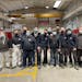 In a photo from Pietro Senna, Alfredo Lupi, fifth from right, poses with his co-workers at the Senna Inox factory in Graffignana, Italy, Dec. 23, 2021