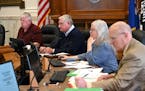 Crow Wing County Commissioners Doug Houge, Steve Barrows and Rosemary Franzen, along with Crow Wing County Attorney Don Ryan, right, listened to speak