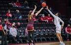 Sara Scalia of the Gophers took a long-range shot over Joiya Maddox of Rutgers on Thursday night in New Jersey.