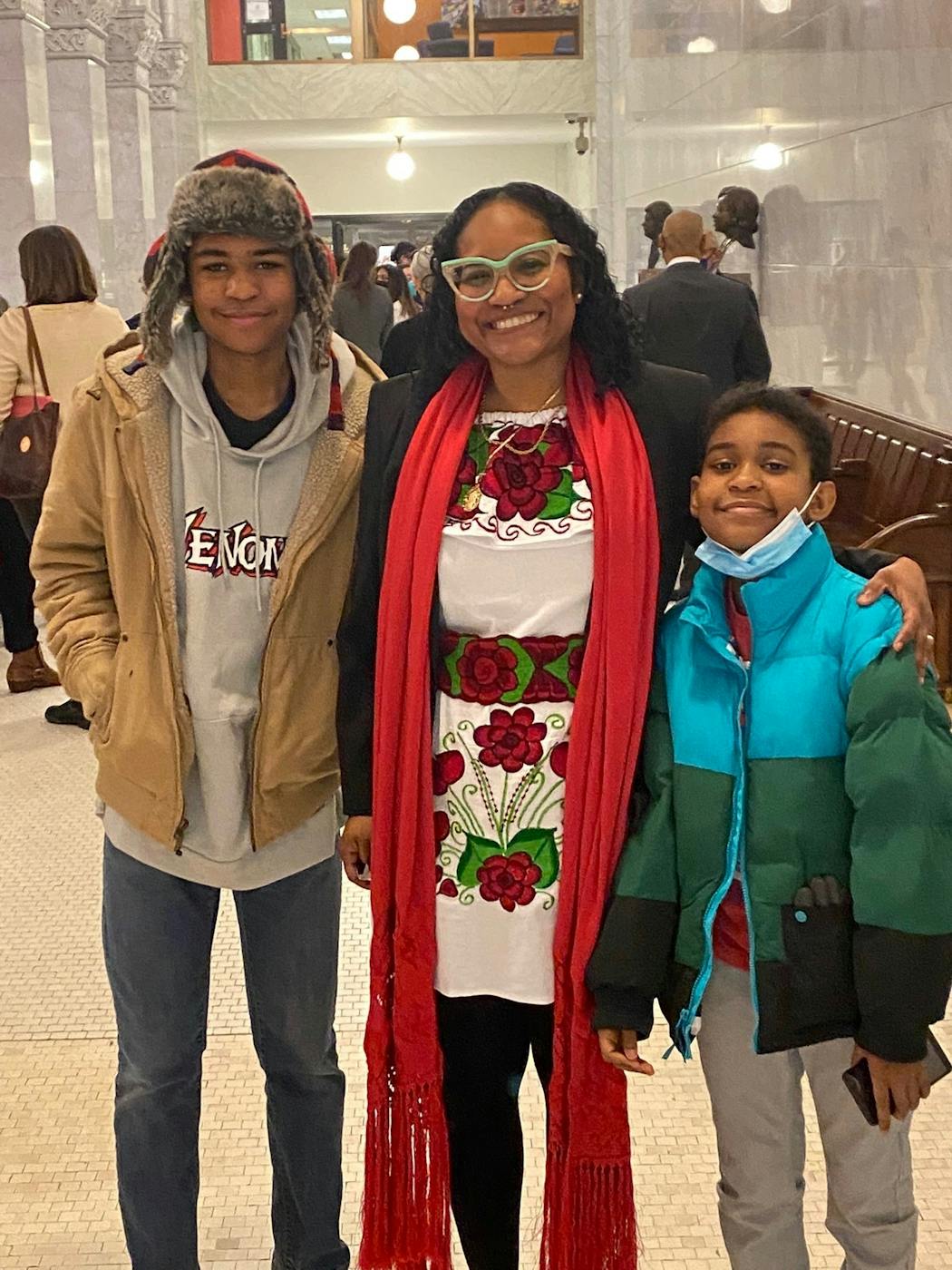 Samantha Pree-Stinson with her sons Gabriel, left, and Noah, right, on Jan. 3, 2022, the day she was sworn in to her seat on the Minneapolis Board of Estimate and Taxation.