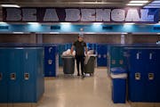 Connor Bayerkohler emptied trash and recycling bins in the commons area at Blaine High School on Thursday. Blaine High School has hired students after