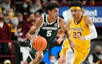 Michigan State guard Max Christie, left, brings the ball down court past Minnesota guard Eylijah Stephens during the second half Dec. 8, 2021.
