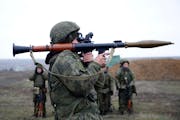 Russian troops take part in drills at the Kadamovskiy firing range in the Rostov region near its border with Ukraine on, Dec. 14, 2021. 