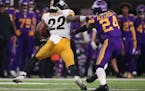 Minnesota Vikings cornerback Mackensie Alexander (24) tried to get a hand on Pittsburgh Steelers running back Najee Harris (22) as he rushed the ball 