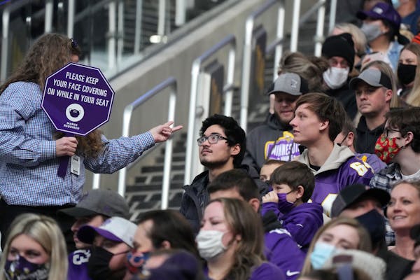 A U.S. Bank Stadium worker reminded fans to wear their face masks in the first quarter of an NFL game between the Minnesota Vikings and the Chicago Be