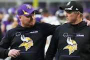 Vikings coach Mike Zimmer, right, with his son Adam, the team’s co-defensive coordinator, after Sunday’s 31-17 victory over the Bears.
