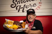 Dave Anderson with the All-American Feast at Famous Dave’s, the restaurant he founded.