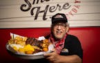 Dave Anderson with the All-American Feast at Famous Dave’s, the restaurant he founded.