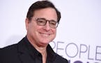 FILE - Bob Saget arrives at the People’s Choice Awards at the Microsoft Theater on Wednesday, Jan. 18, 2017, in Los Angeles. Saget, a comedian and a