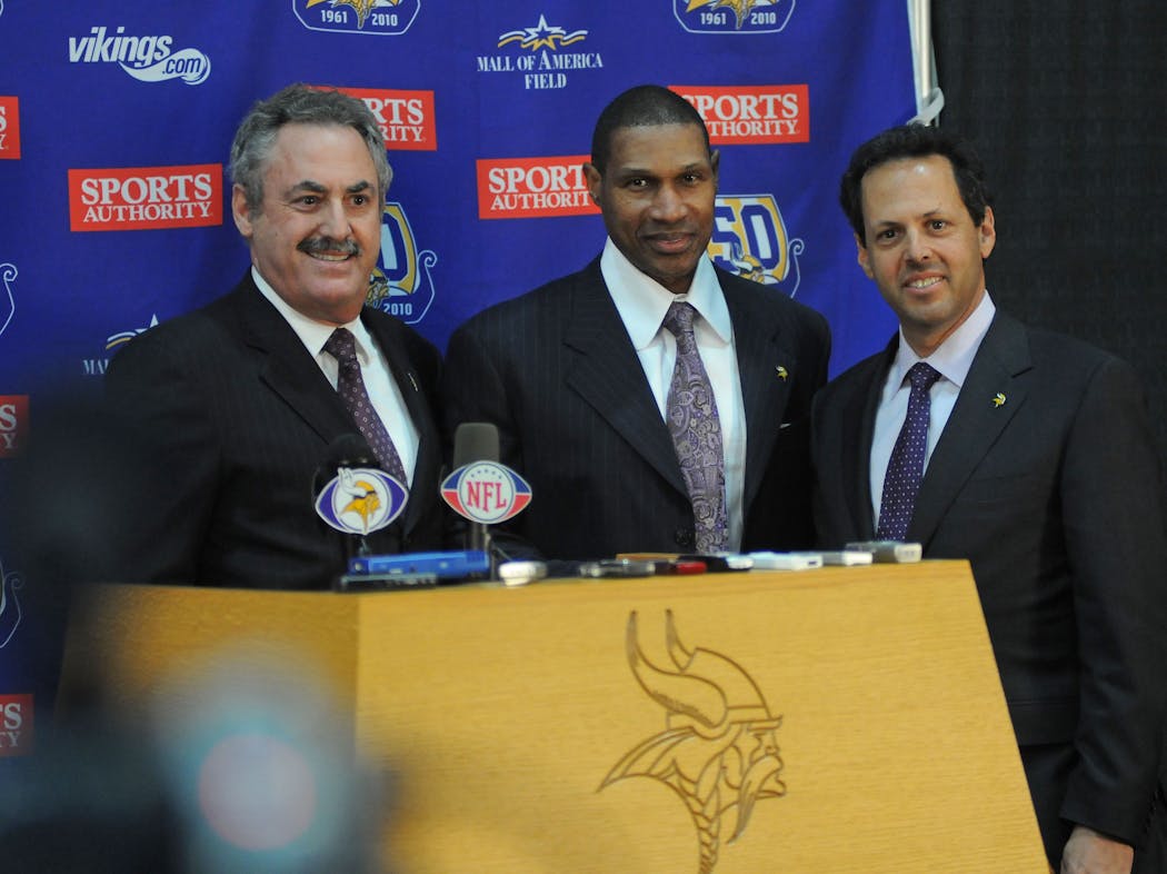 Zygi Wilf and Mark Wilf posed for a photo with Leslie Frazier when Frazier was moved from interim to permanent head coach in 2011. 