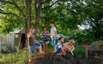 Neighborhood kids played on top of dirt pile at the Old Highland Peace Garden in August as their parents picked weeds and barbecued nearby.