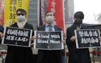 Protesters from Hong Kong in Taiwan and local supporters hold slogans reading “Protest Against Totalitarian Liquidation of Stand News” and “Supp