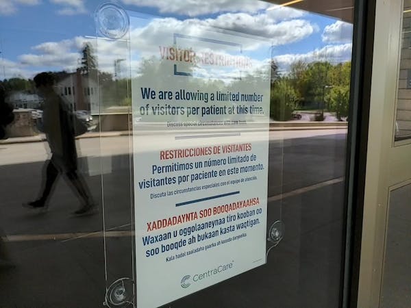 A sign outside St. Cloud Hospital alerts guests to the visitor policy.