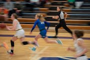 Leah Johnson kept pace with a fast break while officiating the first half of the Edina vs. Eagan girl’s varsity game at Eagan High School Monday nig