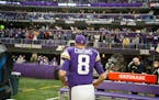 Minnesota Vikings quarterback Kirk Cousins (8) runs off the field after an NFL football game against the Chicago Bears, Sunday, Jan. 9, 2022, in Minne