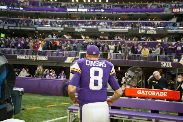 Minnesota Vikings quarterback Kirk Cousins (8) runs off the field after an NFL football game against the Chicago Bears, Sunday, Jan. 9, 2022, in Minne