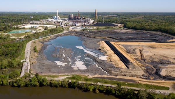 The skyline of Richmond, Va., behind the coal ash ponds along the James River near Dominion Energy’s Chesterfield Power Station in Chester, Va. 