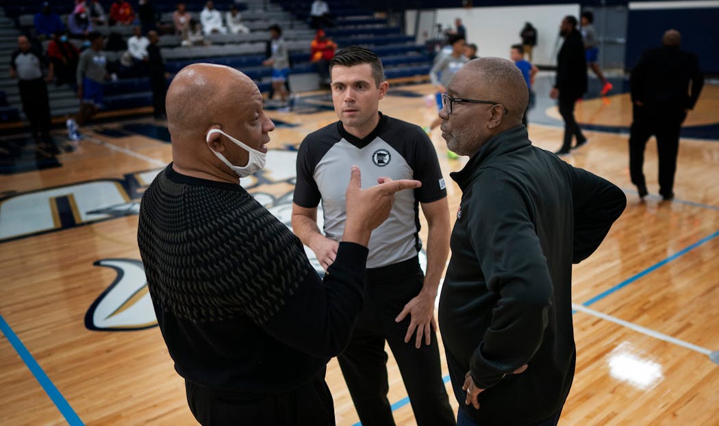 Coach Greg Wise, left, of Jack Yates Houston, spoke with Minneapolis North coach Larry McKenzie in December at the George Floyd Jr. Memorial Holiday Classic.