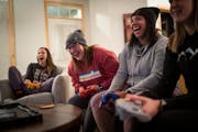 Hannah Justin, Cat Urlich, Aubrey Davis and Lizzie Stenhaug play Mario Kart on Nintendo 64 during game night at Stenhaug’s Golden Valley home on Fri