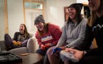 Hannah Justin, Cat Urlich, Aubrey Davis and Lizzie Stenhaug play Mario Kart on Nintendo 64 during game night at Stenhaug’s Golden Valley home on Fri