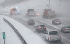 Traffic creeps behind snow plows heading south on I-35W in Minneapolis ahead during the beginning of a large snowstorm on Jan. 17, 2020.