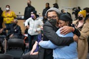Brock Satter, left, hugs Thandisizwe Jackson-Nisan during a gathering to honor longtime civil rights activist and journalist Mel Reeves in Minneapolis