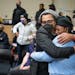 Brock Satter, left, hugs Thandisizwe Jackson-Nisan during a gathering to honor longtime civil rights activist and journalist Mel Reeves in Minneapolis