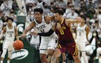 Michigan State guard A.J. Hoggard (11) steals the ball from Gophers guard Payton Willis (0).