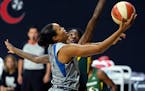 Minnesota Lynx forward Napheesa Collier (24) goes up for a shot in front of Seattle Storm forward Natasha Howard (6) during the first half of Game 2 o