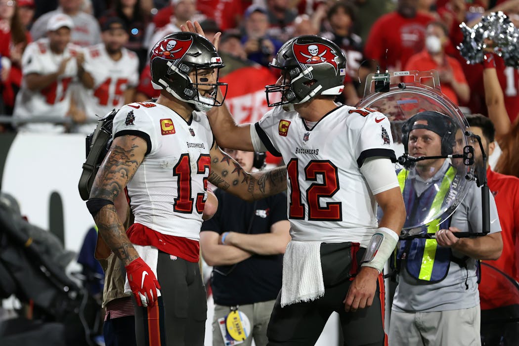 Mike Evans, left, and Tom Brady of the defending champion Buccaneers.