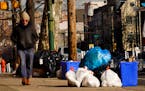 Trash sits out for collection in Philadelphia, Thursday, Jan. 13, 2022.