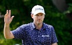 Russell Henley waves after making an eagle on the ninth hole during the second round of the Sony Open at Waialae Country Club in Honolulu