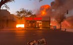 A fire engulves the Max It Pawn shop on Lake Street and 28th Avenue on May 28, 2020.