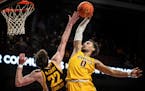 Gophers guard Payton Willis tried to dunk over Hawkeyes forward Patrick McCaffery but missed late in the second half of Iowa’s 81-71 victory at Will