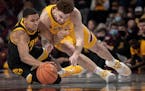 Hawkeyes forward Keegan Murray and Gophers forward Jamison Battle scrambled after a loose ball in the second half at Williams Arena on Sunday.