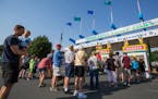 People line up at the main ticket booth on the first day of the State Fair in 2016.
