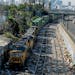 A train passes by shredded boxes and packages at a section of the Union Pacific train tracks in downtown Los Angeles Friday, Jan. 14, 2022. Crews made