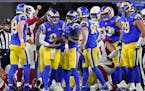 Rams quarterback Matthew Stafford, middle, was congratulated by teammates after scoring a touchdown against the Cardinals.