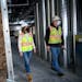 Opus Regional Vice President Beth Duyvejonck, left, and site superintendent Craig Anderson perform a site safety audit in the under-construction multi