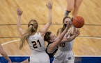 Maddyn Greenway (30) of Providence Academy drives on two defenders during the girls’ 2A basketball tournament in March.