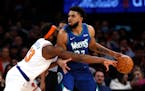 Knicks center Mitchell Robinson defends  Timberwolves center Karl-Anthony Towns during Tuesday’s game. 