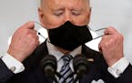 FILE - President Joe Biden takes off his mask to speak about the COVID-19 pandemic during a prime-time address from the East Room of the White House l