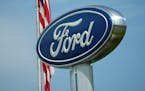 A Ford logo is seen on signage at Country Ford in Graham, N.C., Tuesday, July 27, 2021. Ford is recalling about 200,000 cars in the U.S., Wednesday, J