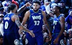 The Minnesota Timberwolves' D'Angelo Russell (0), Karl-Anthony Towns (32), and Jaylen Nowell (4) celebrate during the second half against the New York