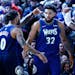 The Minnesota Timberwolves' D'Angelo Russell (0), Karl-Anthony Towns (32), and Jaylen Nowell (4) celebrate during the second half against the New York