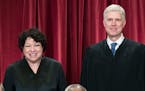 FILE - Associate Justice Sonia Sotomayor, left, and Associate Justice Neil Gorsuch, gather with other justices of the U.S. Supreme Court for an offici