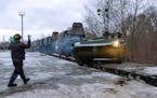 In this photo taken from video provided by the Russian Defense Ministry Press Service, A Russian armored vehicle drives off a railway platform after a